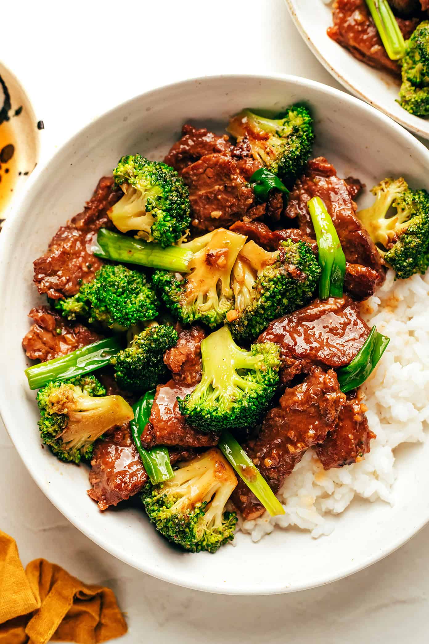 beef and broccoli served over rice in bowl