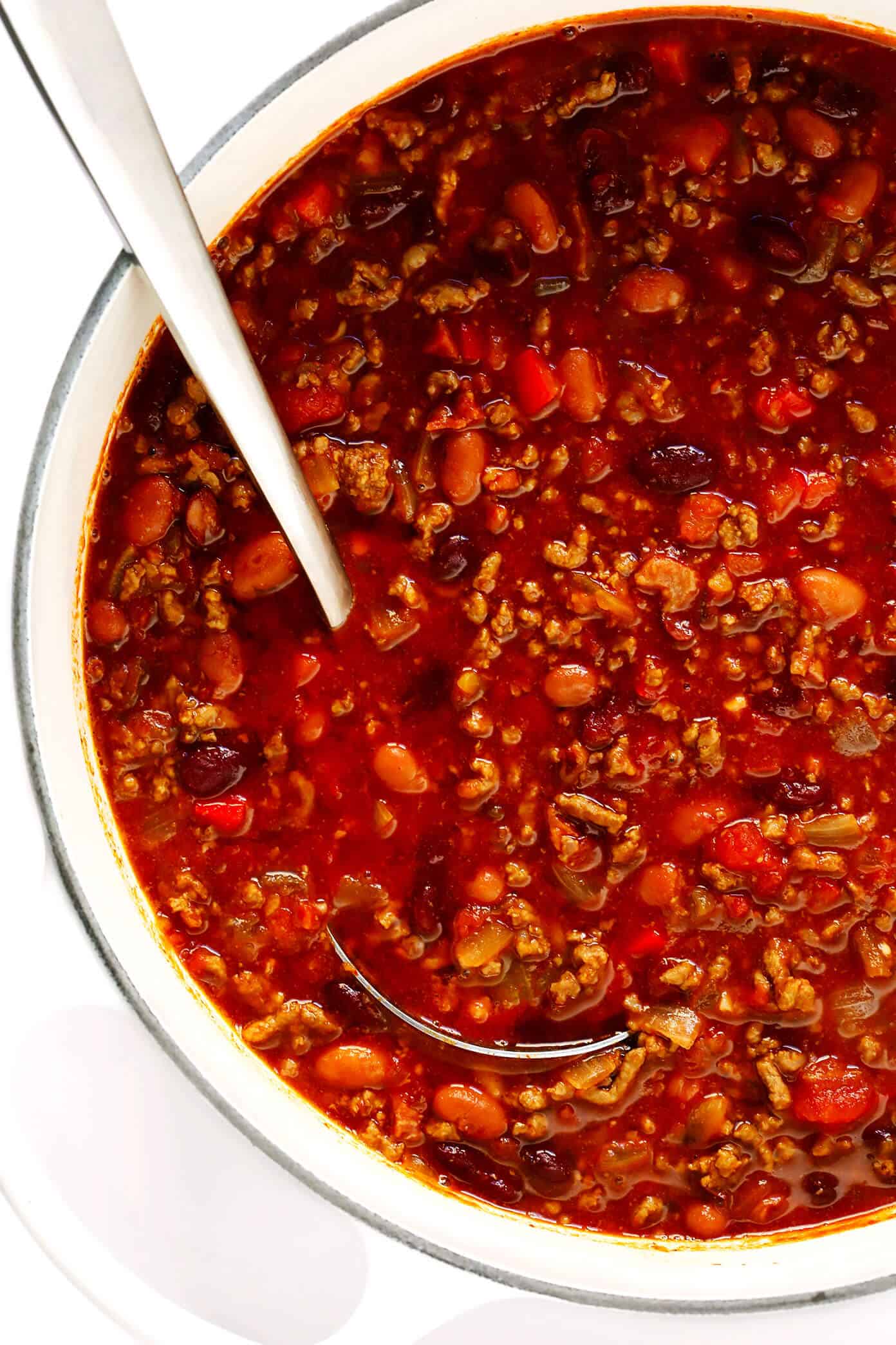 The BEST chili recipe -- made with beef, beans, veggies and the most deliciously seasoned tomato soup broth. Easy to make on the stovetop or in the Instant Pot (pressure cooker) or Crockpot (slow cooker), and always a crowd fave!! | gimmesomeoven.com #chili #soup #stew #dinner #football #mealprep #freezermeal #beef #glutenfree The BEST Chili Recipe