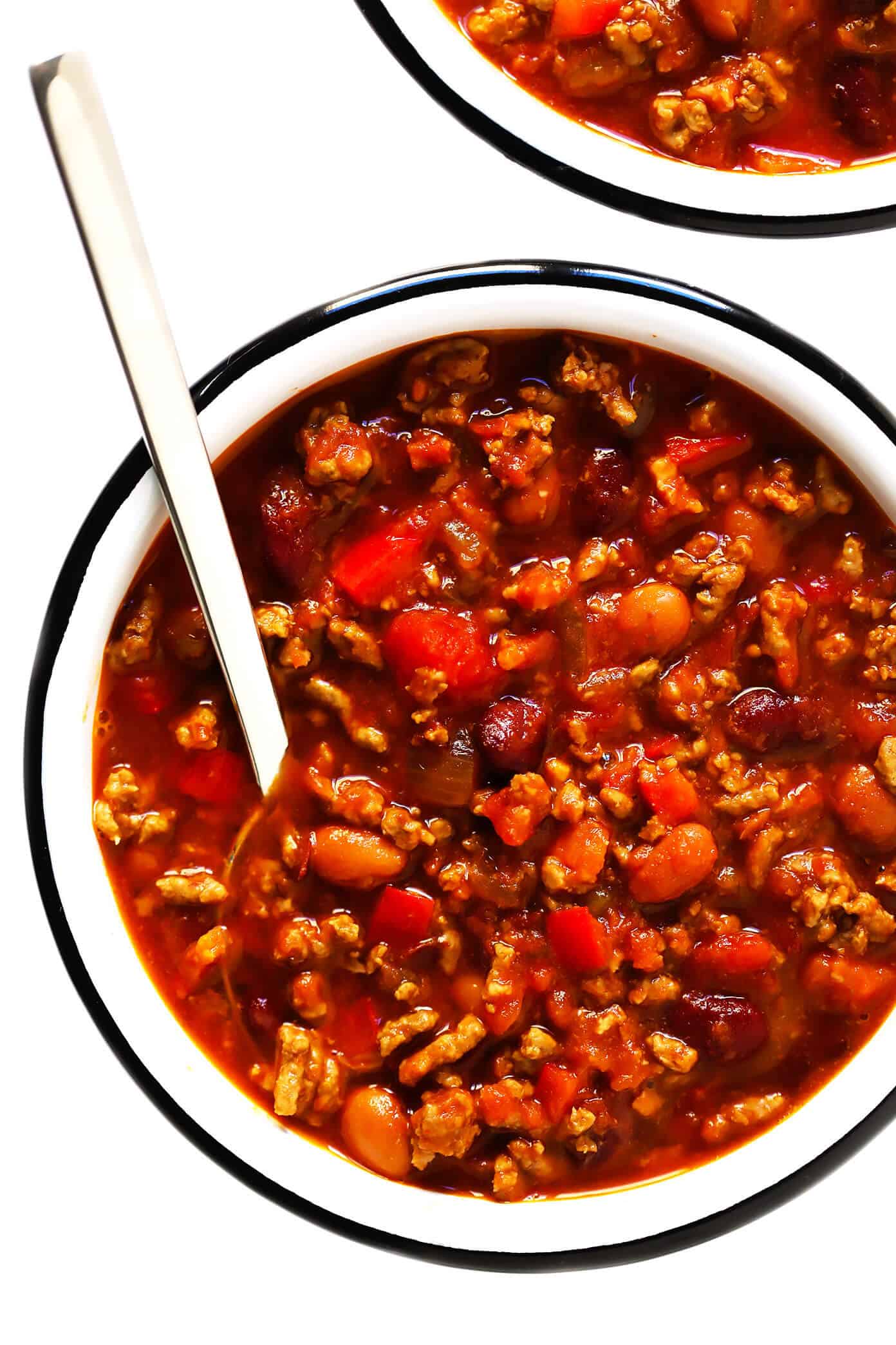 The BEST chili recipe -- made with beef, beans, veggies and the most deliciously seasoned tomato soup broth. Easy to make on the stovetop or in the Instant Pot (pressure cooker) or Crockpot (slow cooker), and always a crowd fave!! | gimmesomeoven.com #chili #soup #stew #dinner #football #mealprep #freezermeal #beef #glutenfree Chili Recipe with Beans and Beef