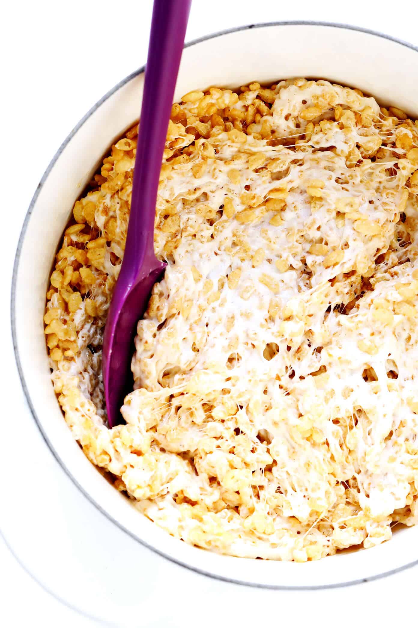 The classic 3-ingredient Rice Krispie Treats recipe is kicked up an irresistible notch with brown butter, toasted marshmallows, a splash of bourbon (if you'd like), and an extra pinch of sea salt. Always a delicious and nostalgic easy dessert recipe! | gimmesomeoven.com #ricekrispies #treats #cereal #dessert #vegan #treat #marshmallow Stirring Rice Krispie Treats